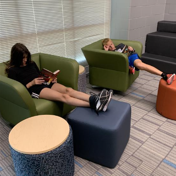 Students relax and read their library books.
